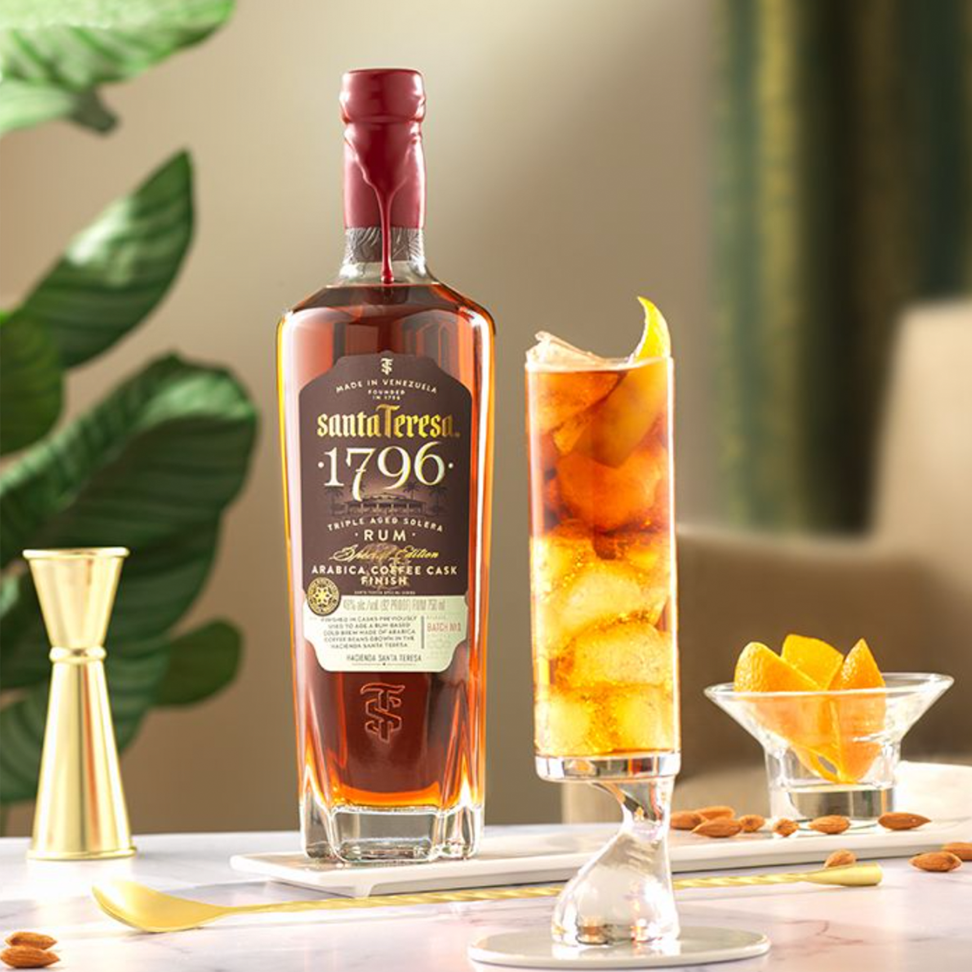 Santa Teresa 1796 Arabica Coffee Cask Finish Rum bottle with a cocktail and garnishes on a stylish table.