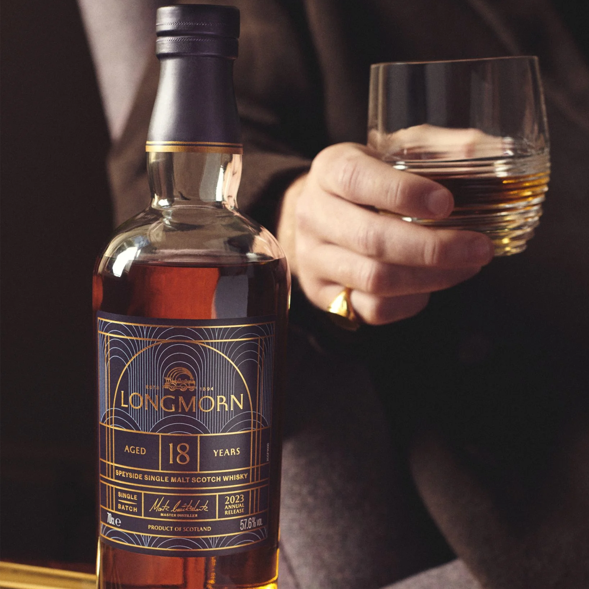 Longmorn 18 Year Speyside Single Malt Scotch whisky bottle with a glass, showcasing rich flavors and iconic profile.
