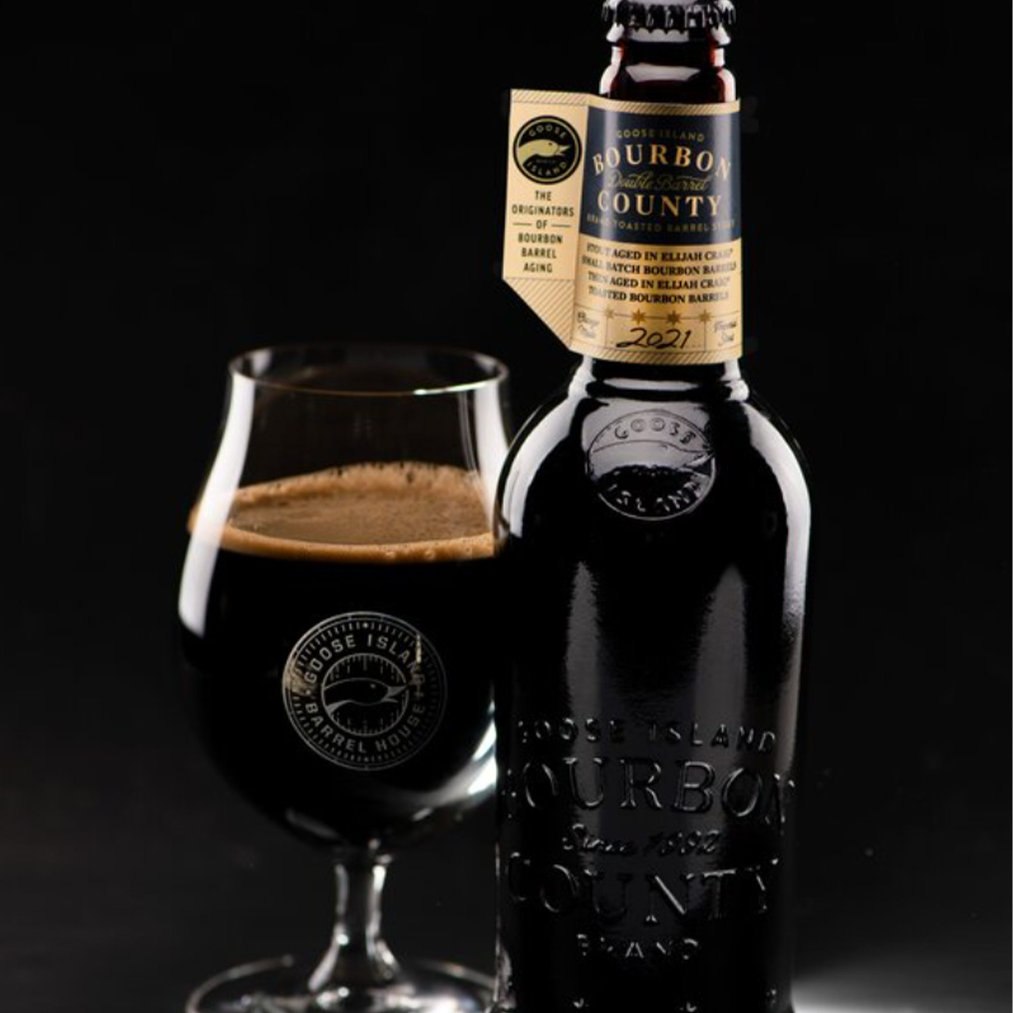 Goose Island Bourbon County Double Barrel Toasted Elijah Craig Stout 2021 in glass against a black background.