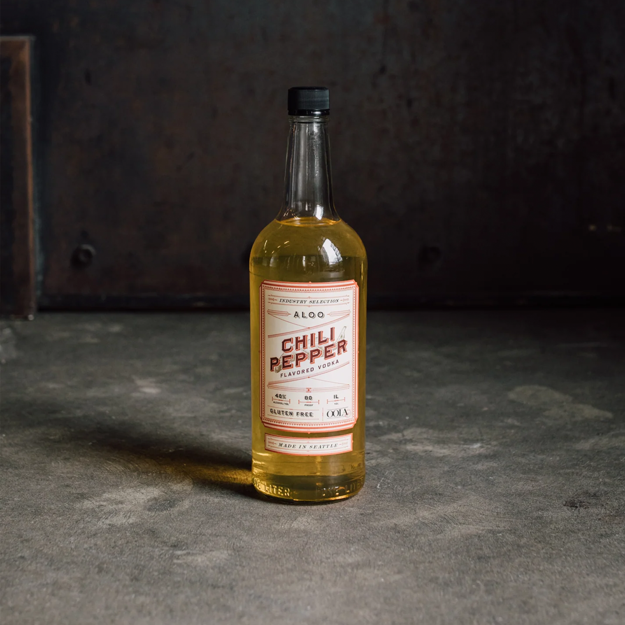 Bottle of OOLA Distillery Aloo Chili Pepper Vodka 1L, vibrant with chili pepper flavor, gluten-free.
