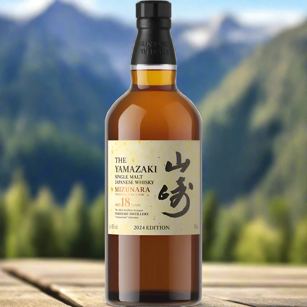 Yamazaki Mizunara 18 Year 2024 Edition Japanese Single Malt whisky bottle on a wooden surface with mountains in the background.