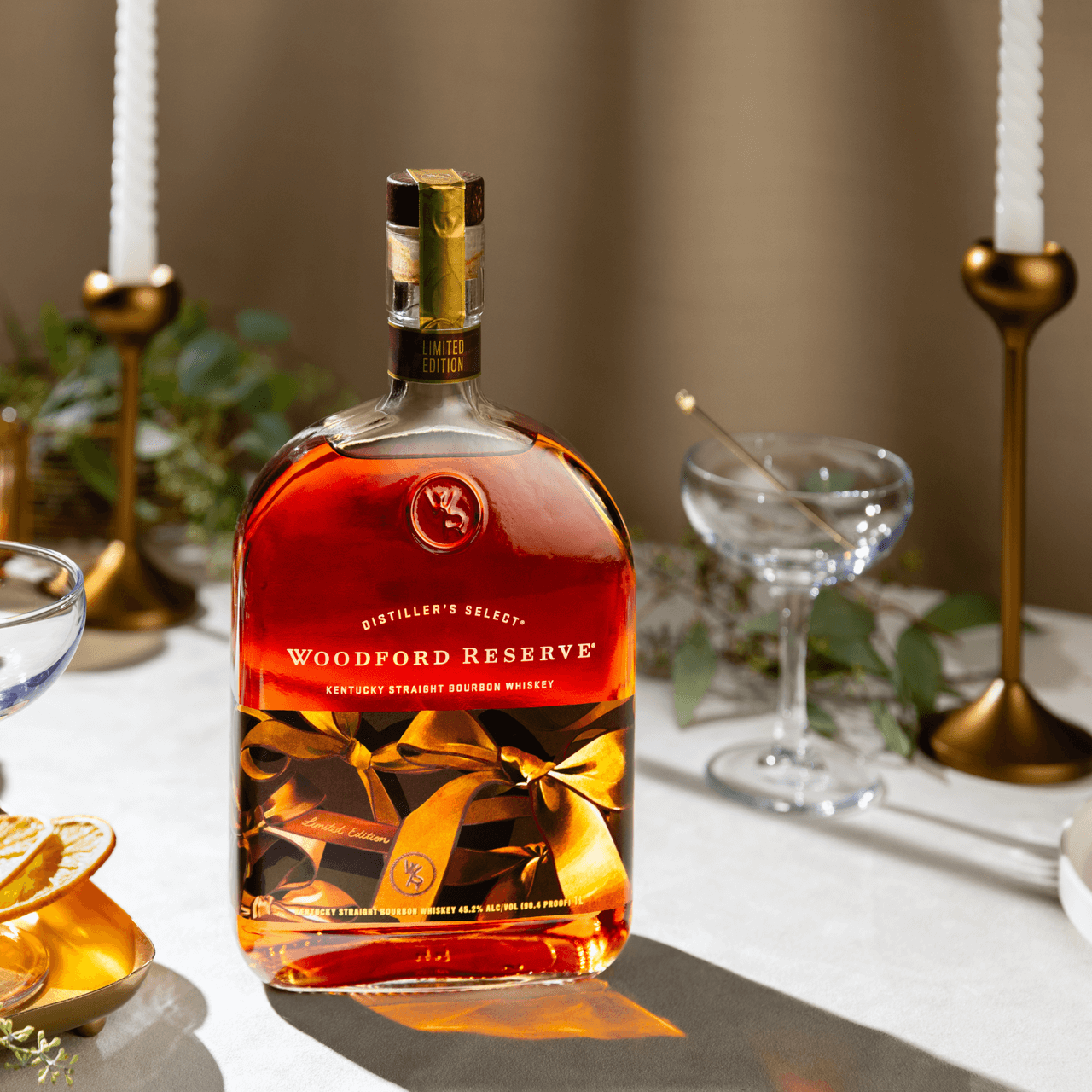 Woodford Reserve Limited Edition bourbon bottle elegantly displayed with festive decor and glassware.