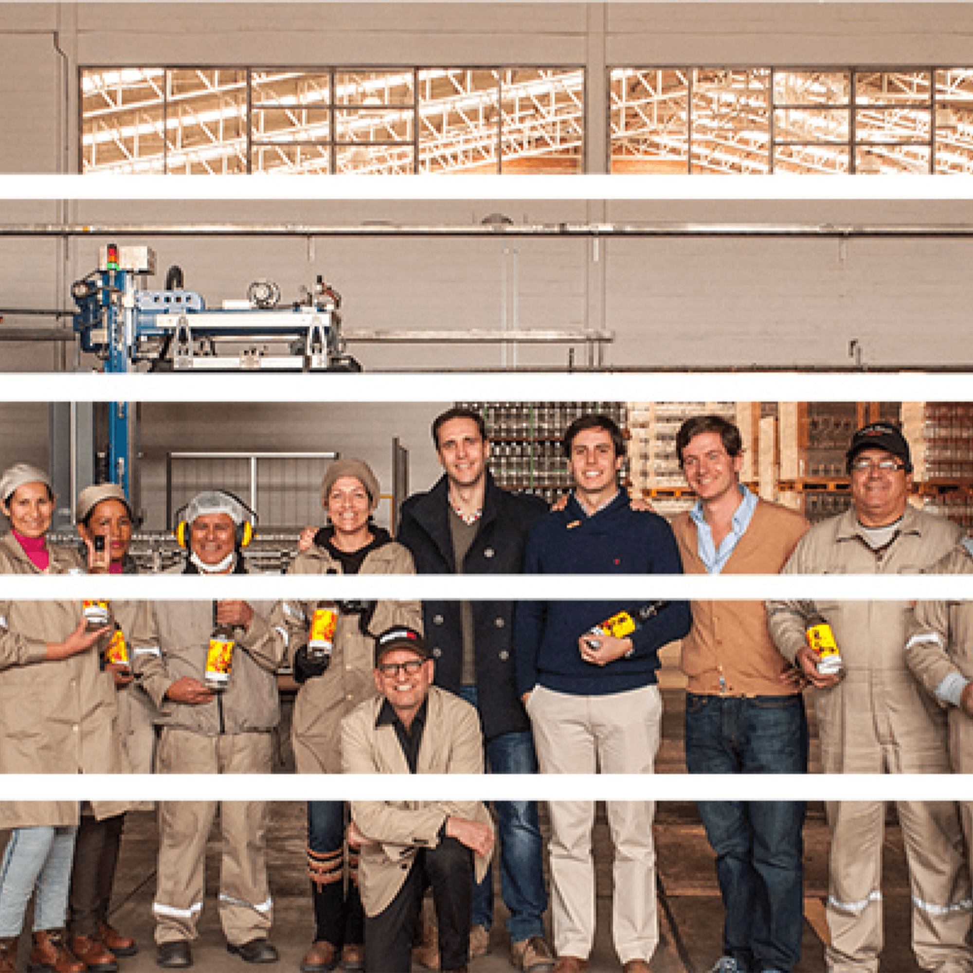 Group portrait of Singani 63 team members in production facility, celebrating their unique Bolivian brandy.