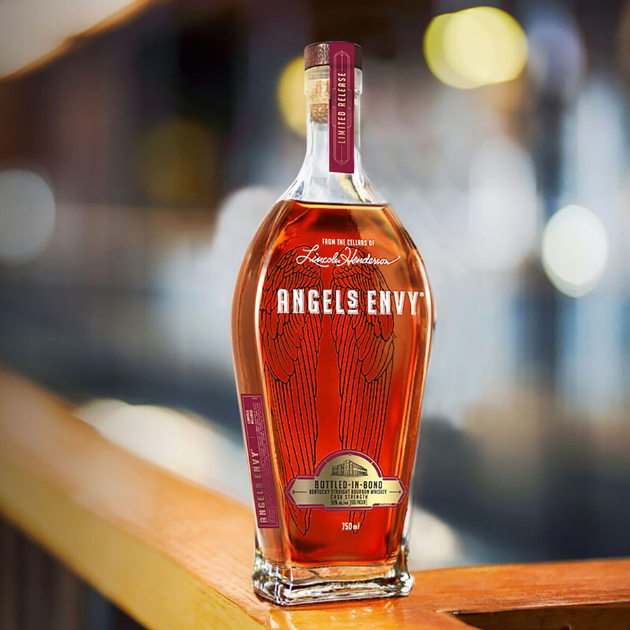 Angel’s Envy Cask Strength Bottled In Bond Bourbon in a decorative bottle on a wooden surface.