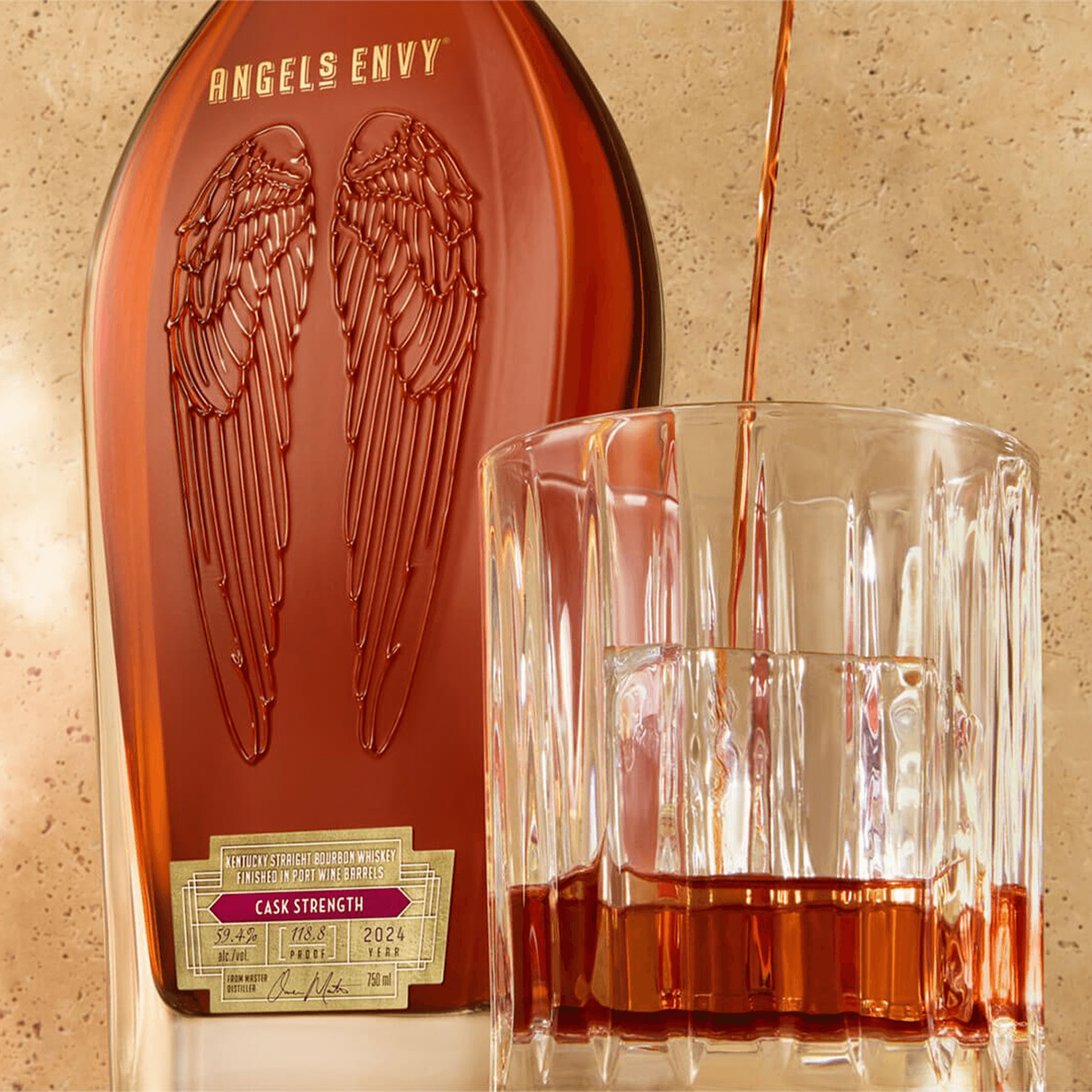 Angels Envy Cask Strength Kentucky Straight 2024 bourbon pouring into glass, showcasing rich amber color and unique design.