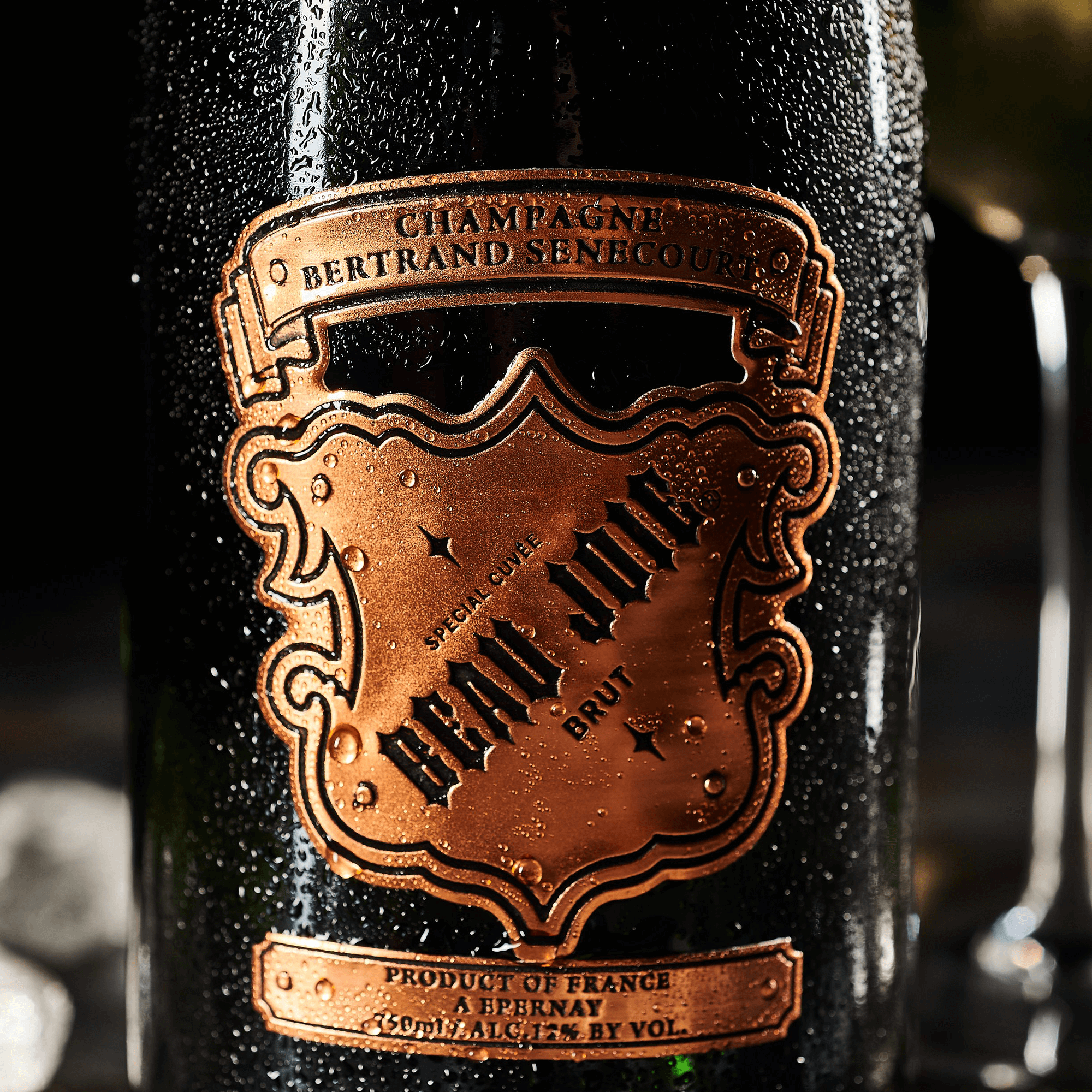 Beau Joie Brut Champagne bottle featuring unique design and label details with condensation.