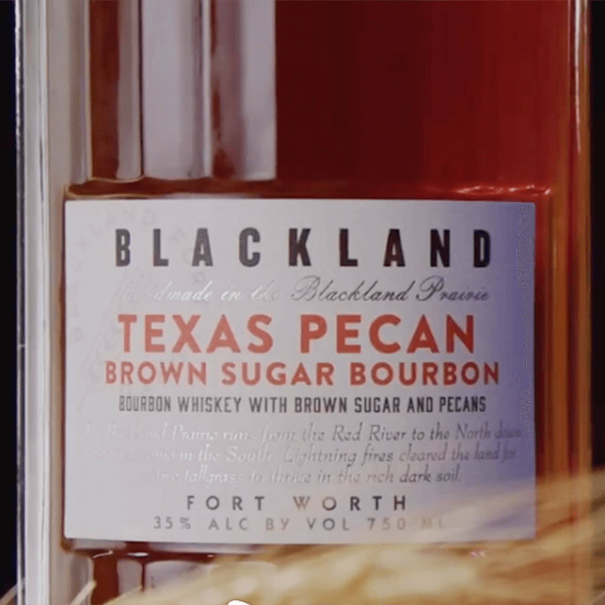 Blackland Texas Pecan Brown Sugar Bourbon bottle close-up, showcasing unique flavor profile and rich bourbon color.