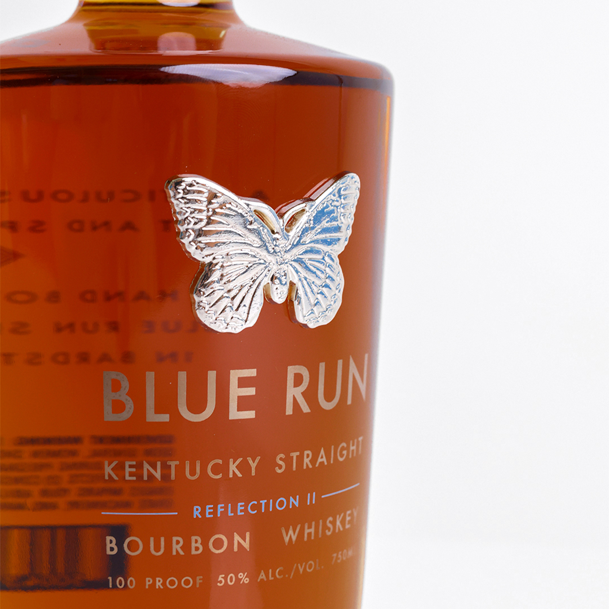 Blue Run Reflection II Bourbon Whiskey bottle featuring a silver butterfly emblem.