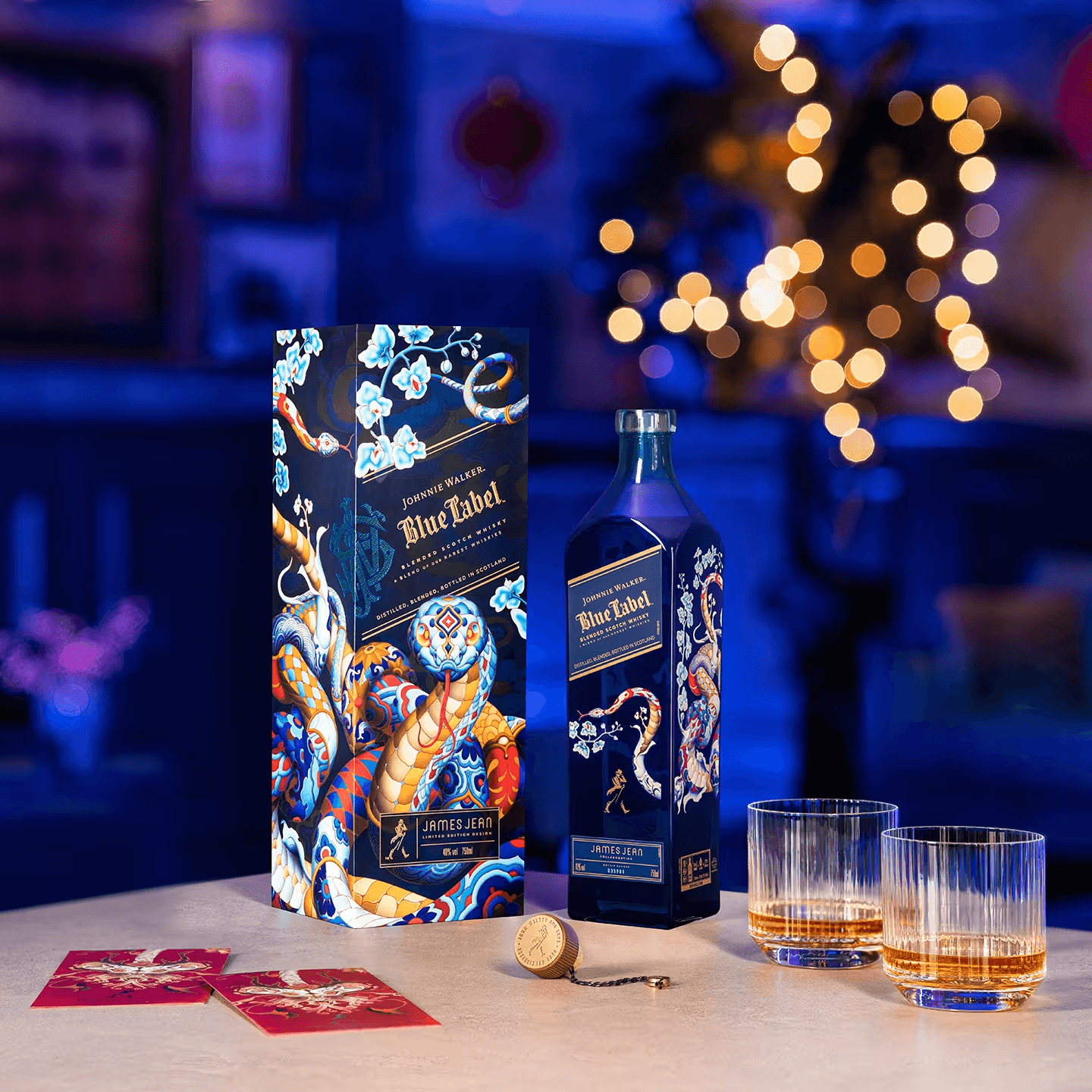 Johnnie Walker Blue Label Year of the Snake limited edition bottle by James Jean with glasses and festive decorations.