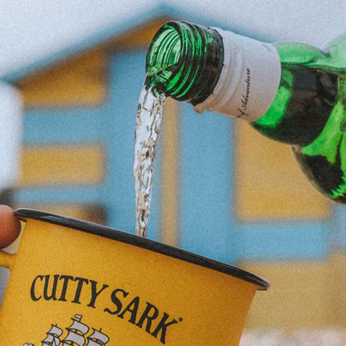 Pouring Cutty Sark Blended Scotch into a yellow cup, showcasing its smooth and mellow whisky profile.