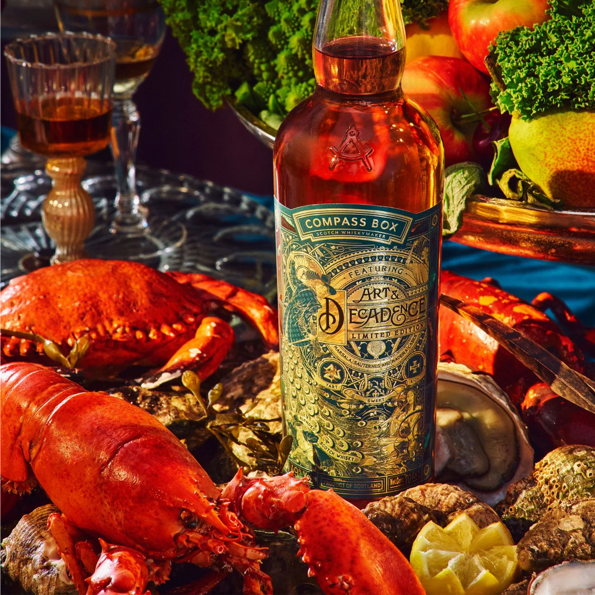Compass Box Art & Decadence 2023 Scotch whiskey bottle surrounded by seafood and fresh produce.