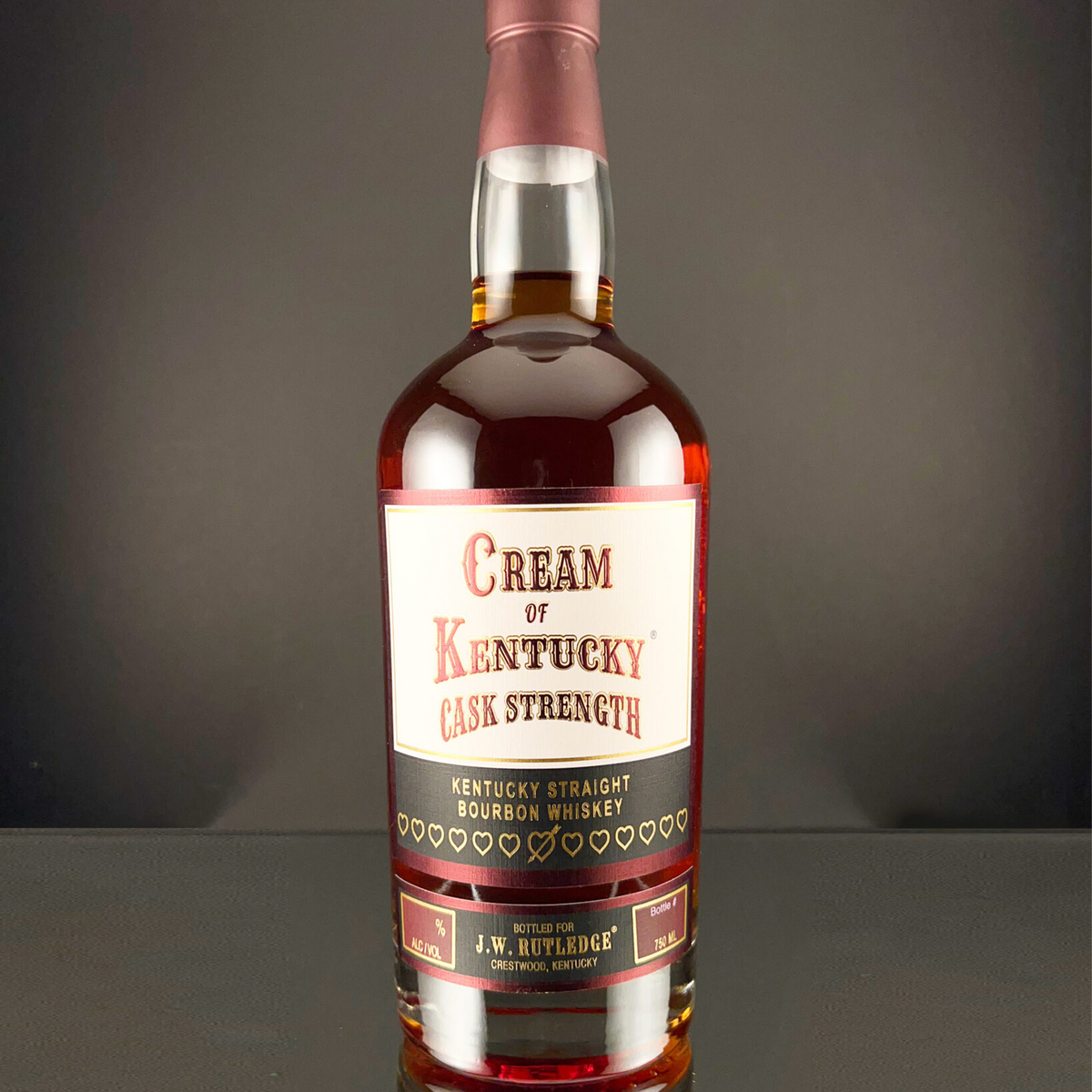 Bottle of Cream of Kentucky Cask Strength Kentucky Straight Bourbon whiskey with vintage label.