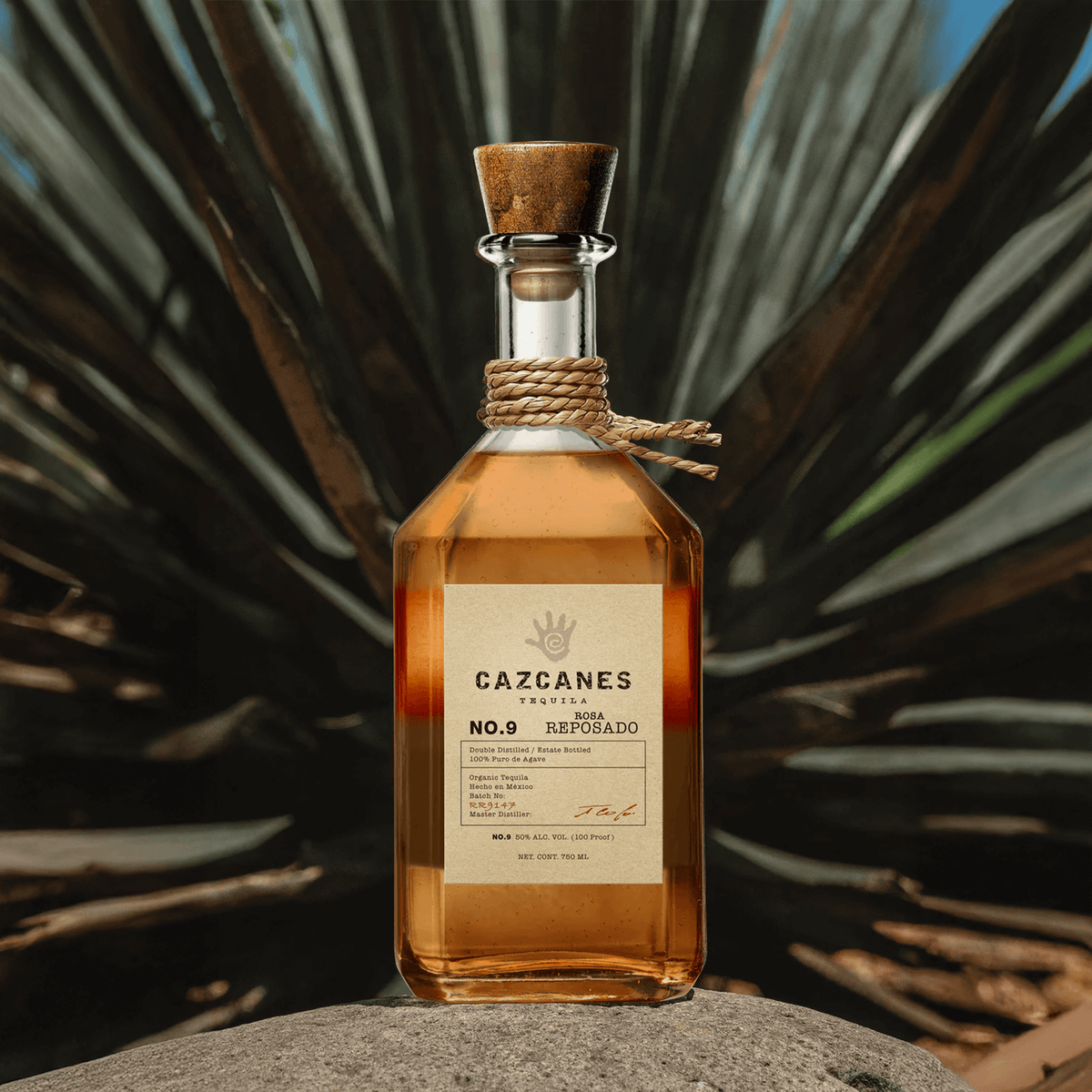 Cazcanes No. 9 Rosa Reposado Tequila bottle with elegant design, showcasing its rich amber color against agave background.