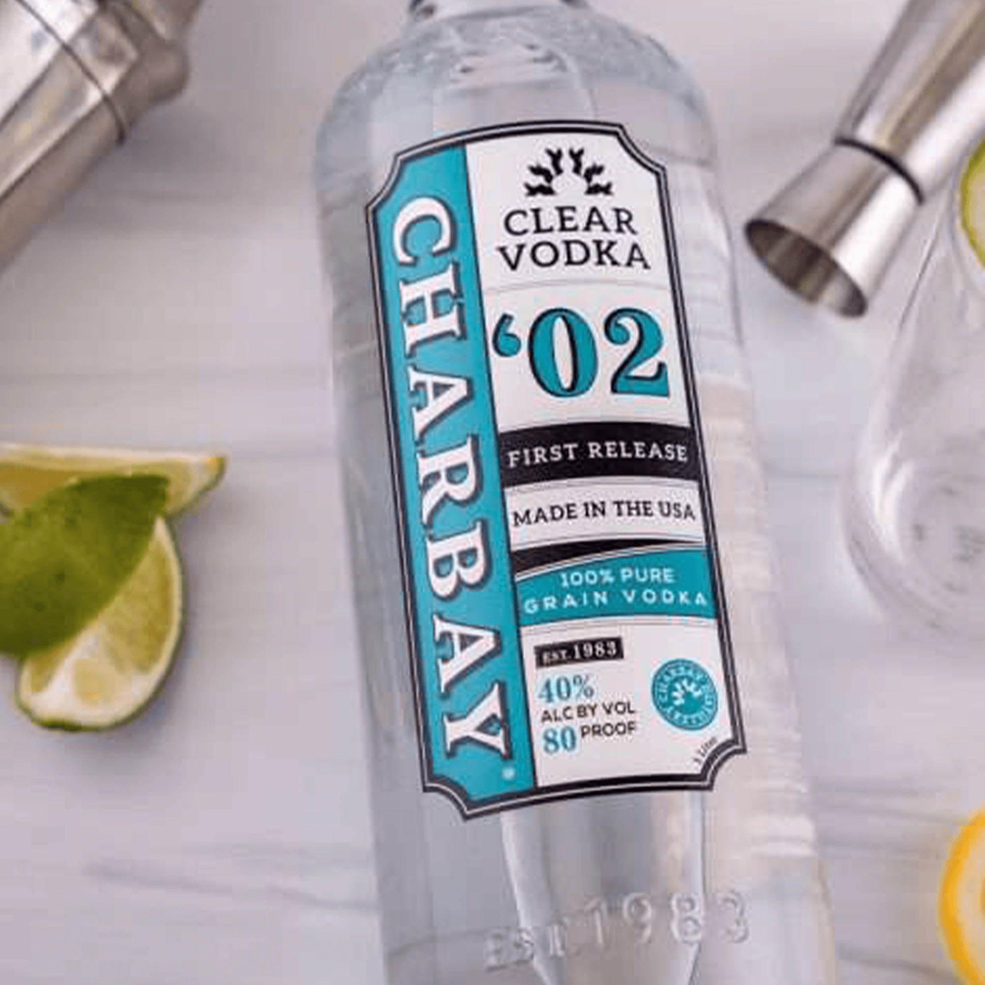 Charbay Clear Vodka bottle made from 100% pure grain, 40% ABV, 80 Proof, served with lime and cocktail shaker.