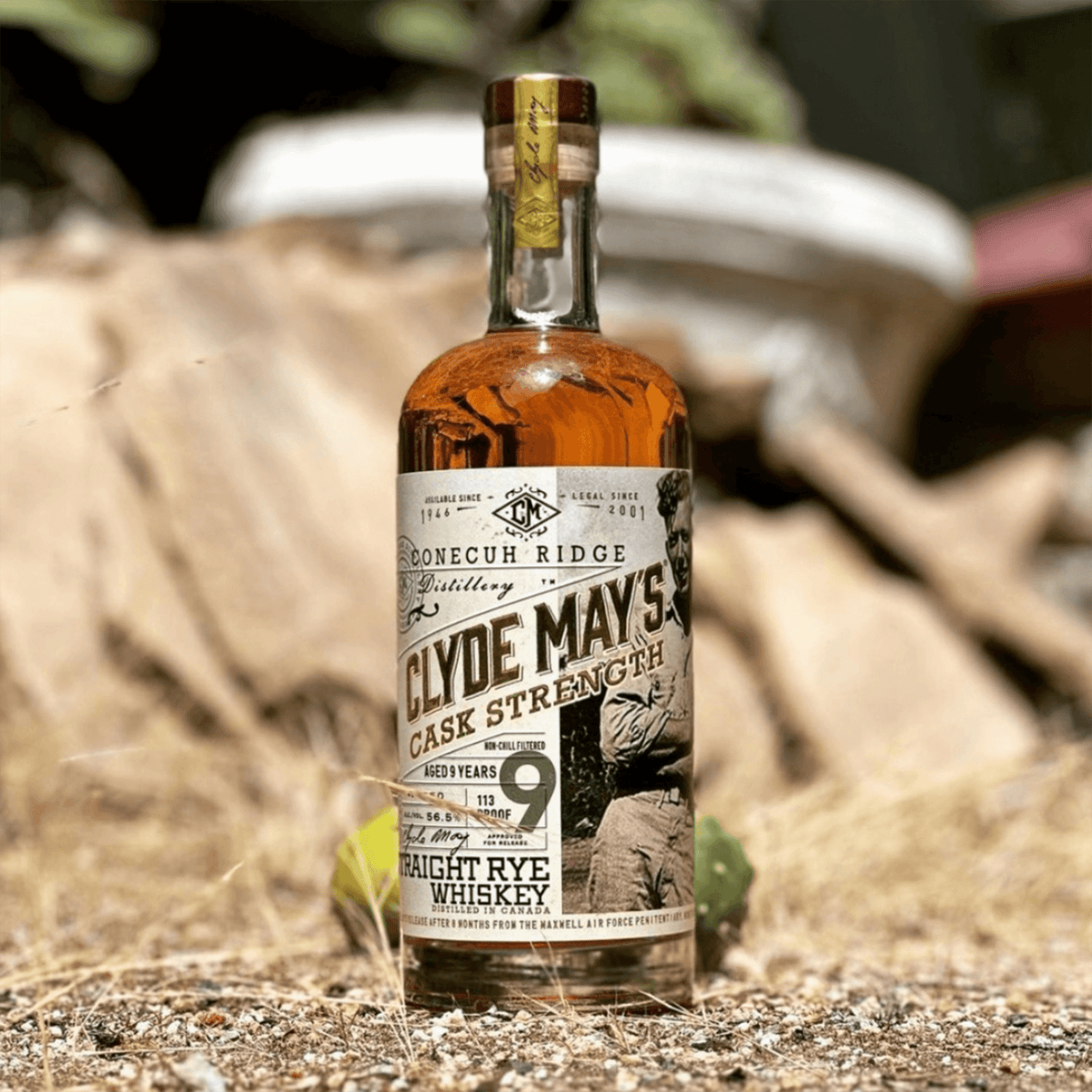 Clyde May's 9 Year Cask Strength Rye whiskey bottle on a rustic background, showcasing its rich amber color and classic label.