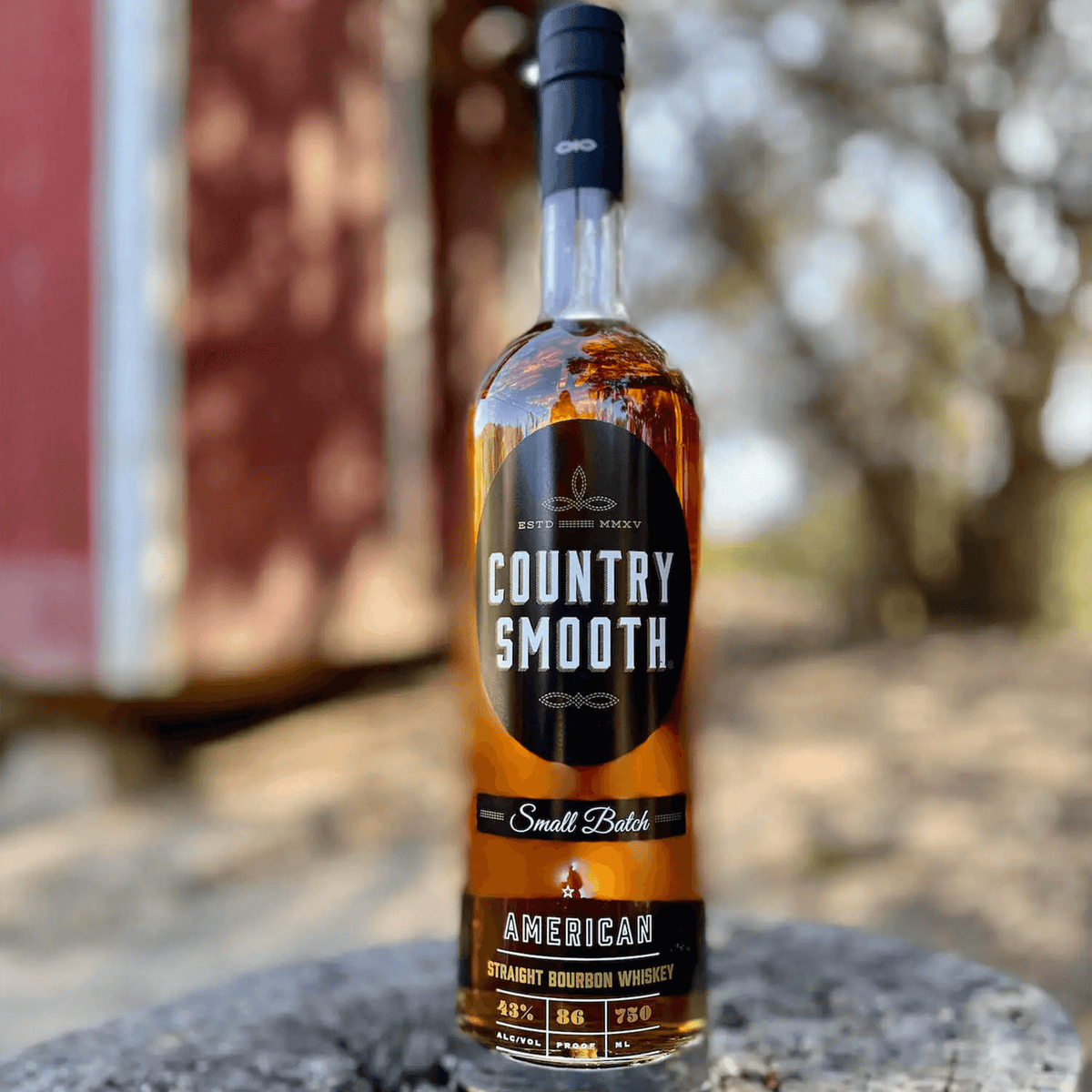 Country Smooth Small Batch Tennessee Straight Bourbon Whiskey bottle with golden hue, showcasing American craftsmanship.
