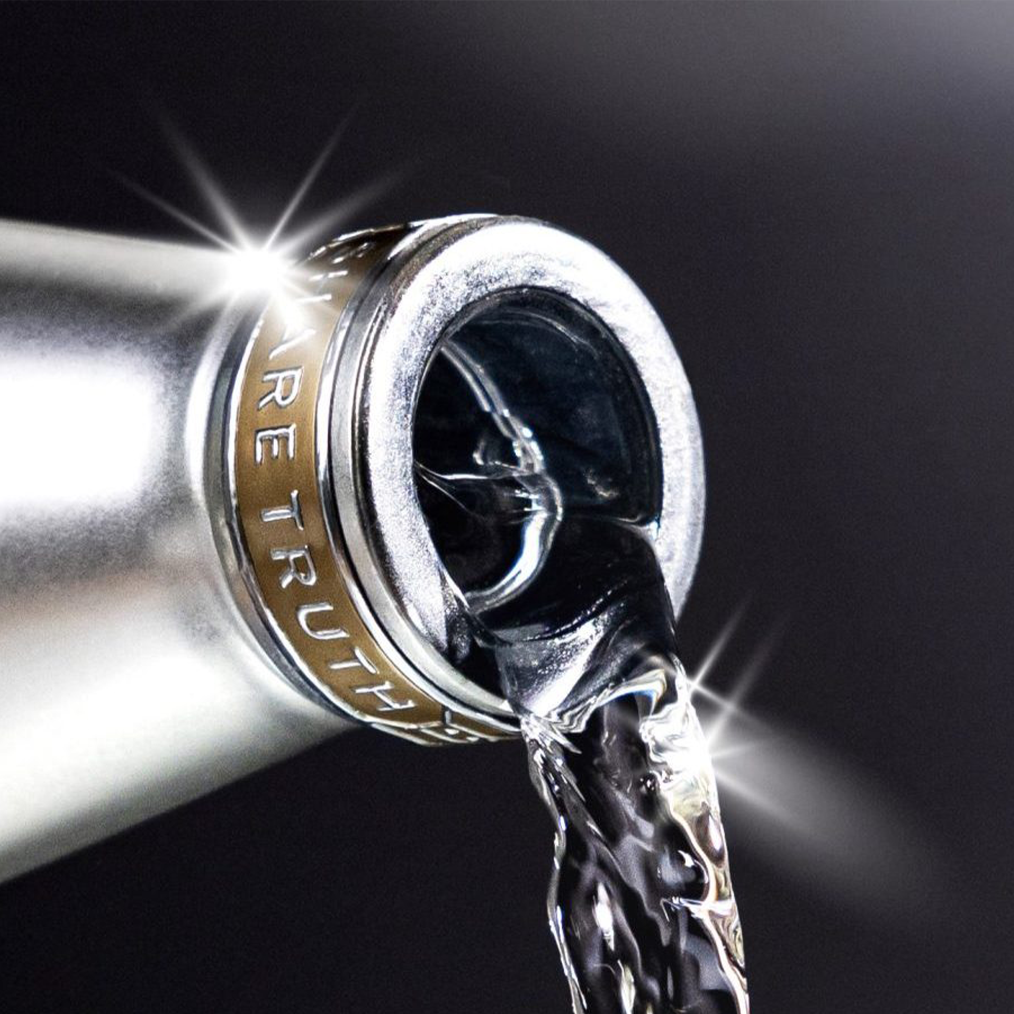 Cincoro Añejo Cristalino Tequila pouring from bottle, showcasing rich, clear liquid and elegant packaging.