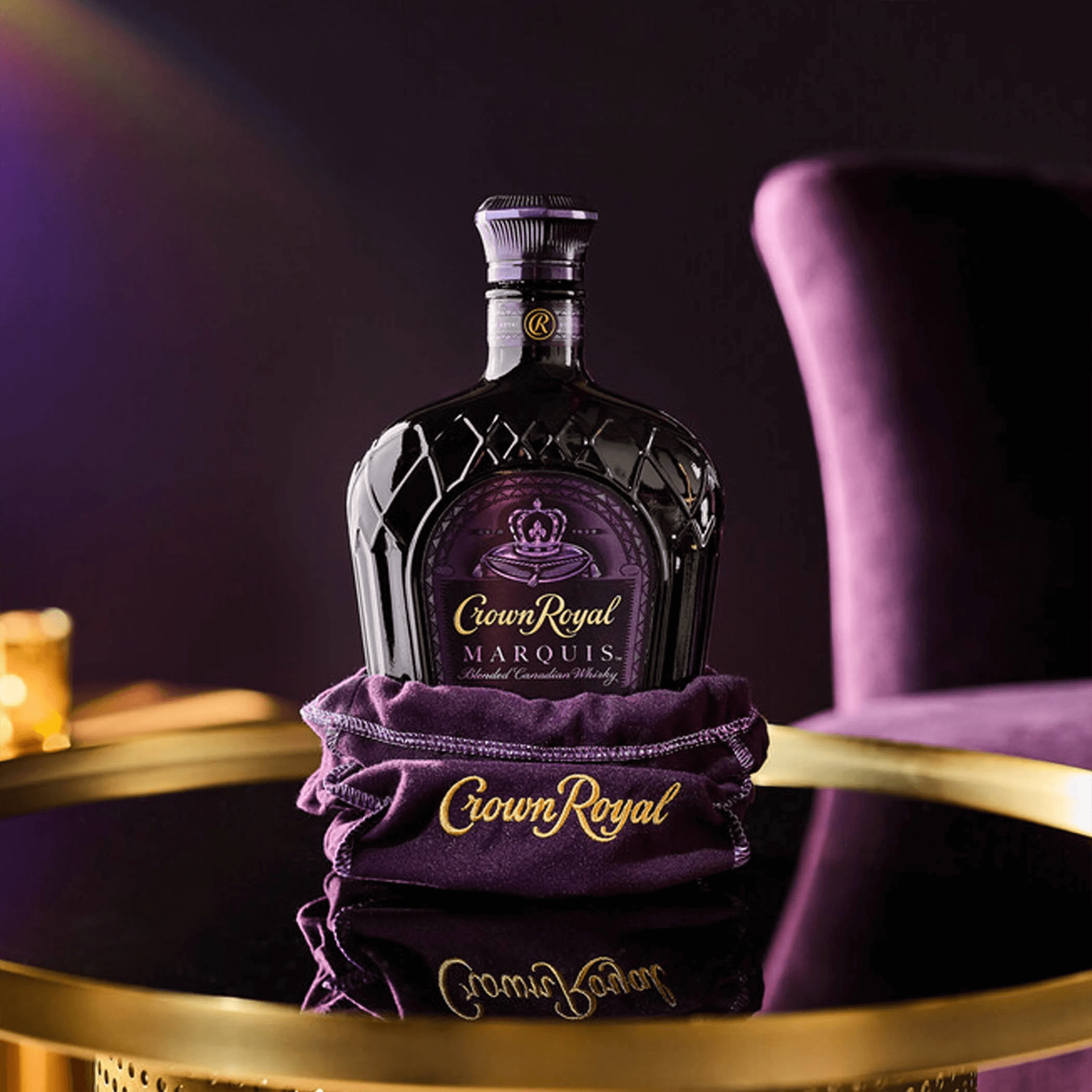 Bottle of Crown Royal Marquis Canadian Whisky on a stylish table, showcasing its elegant packaging.