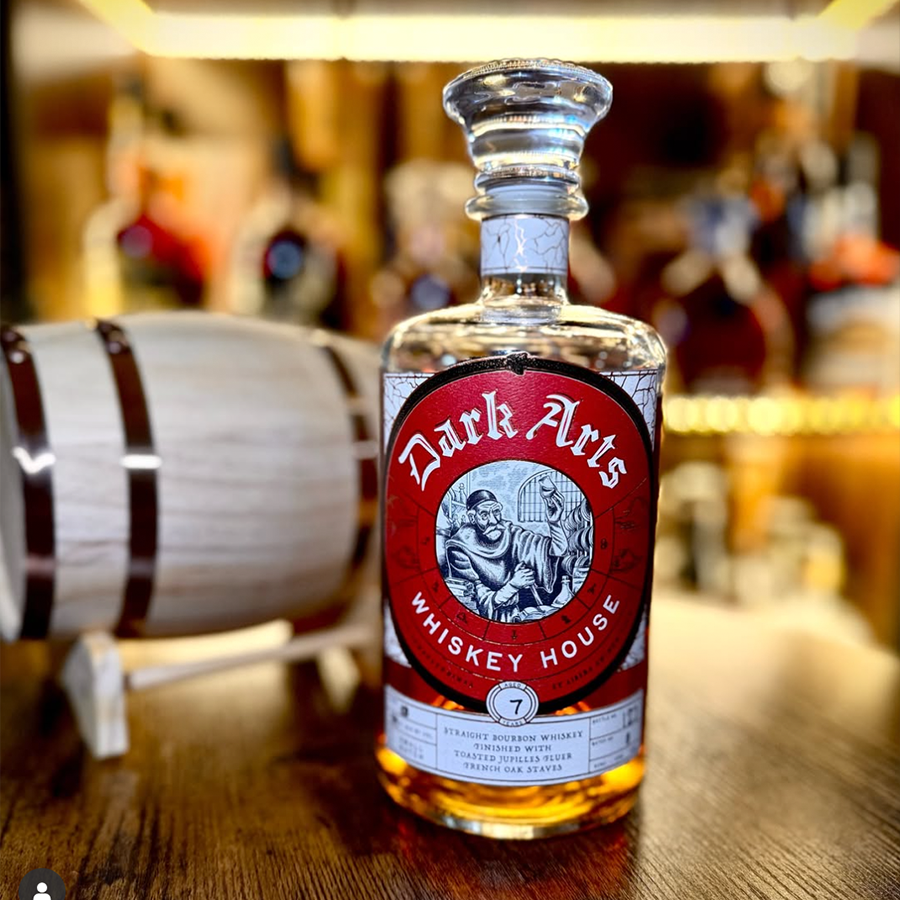 Dark Arts 7 Year French Oak Stave Small Batch Bourbon bottle displayed with barrel.