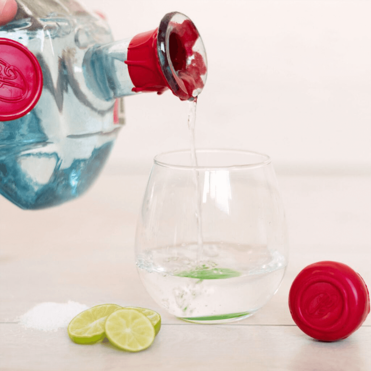 Pouring Dohba Mexicano Mezcal into a glass with lime and salt, showcasing the clear spirit's vibrant character.