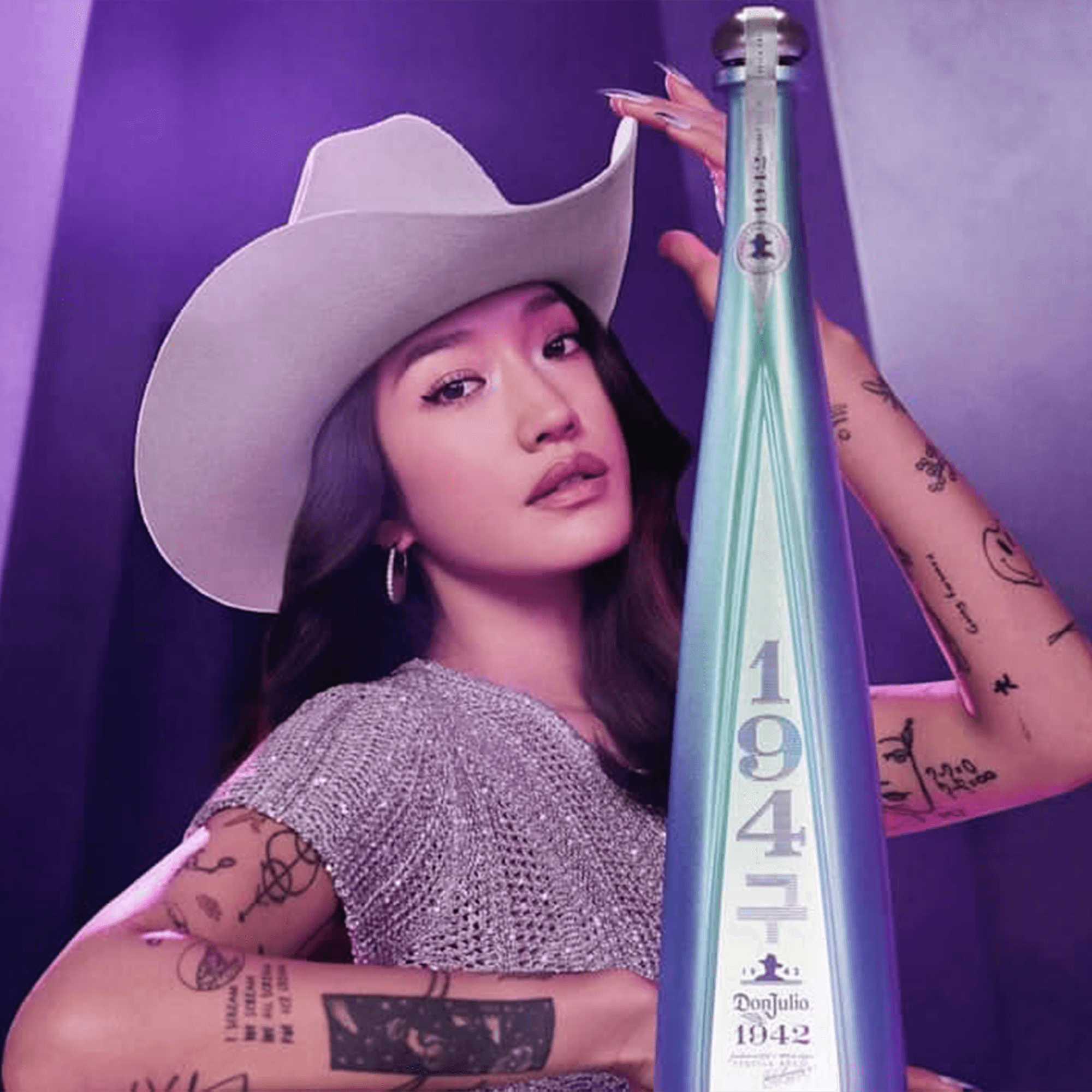 Don Julio 1942 Añejo Tequila bottle next to Peggy Gou, blending style with artisanal craftsmanship.