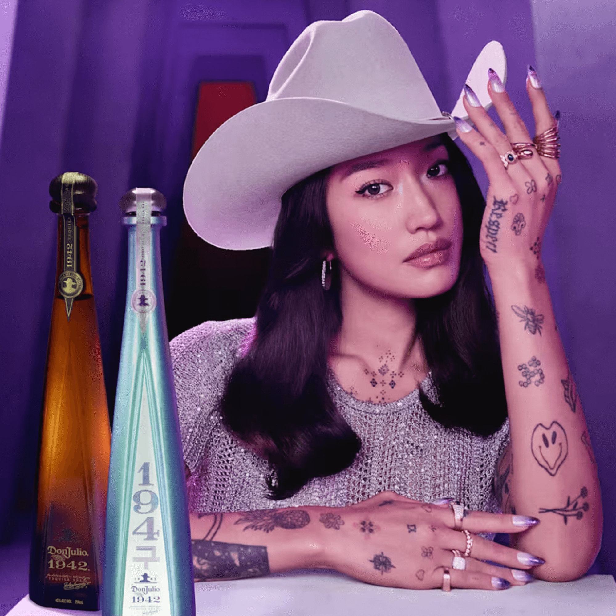 Limited-edition Don Julio 1942 bottles beside Peggy Gou, showcasing her unique style and artistry.