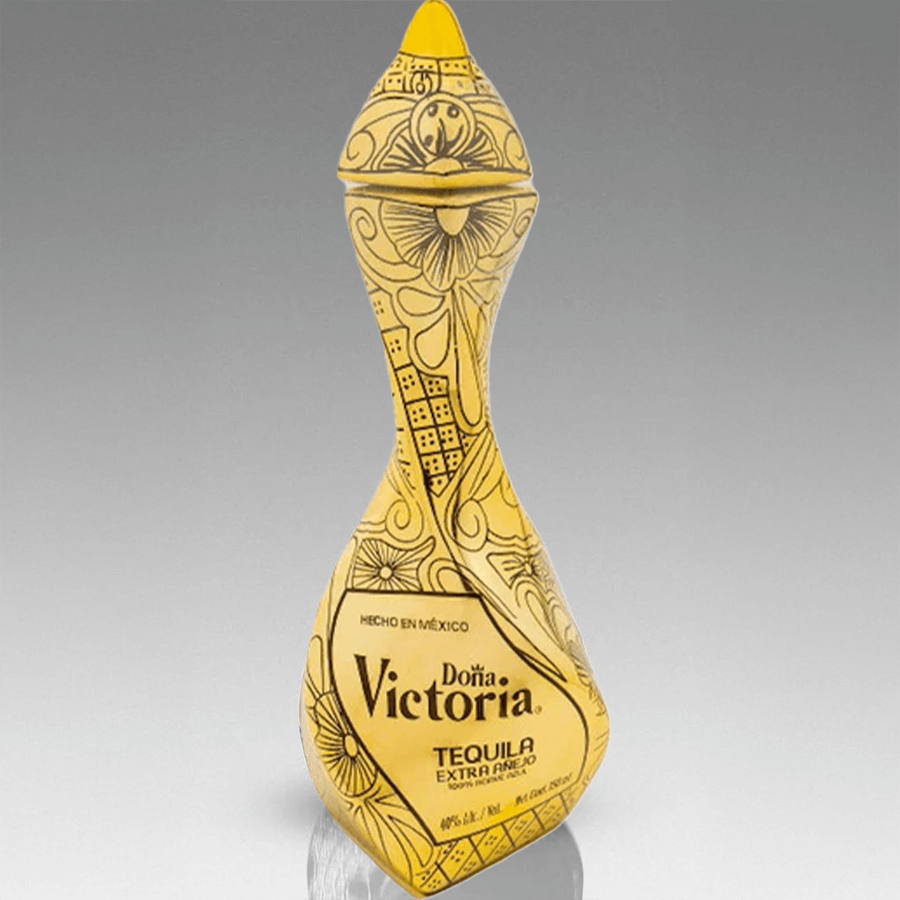 Doña Victoria Extra Añejo Gold Tequila bottle with intricate design, crafted from 100% blue Weber agave, ultra-premium.