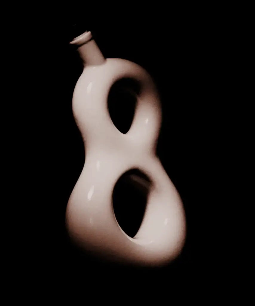 Elegant design of the Eight Reserve Añejo Tequila bottle, showcasing its unique 8 shape in artistic lighting.