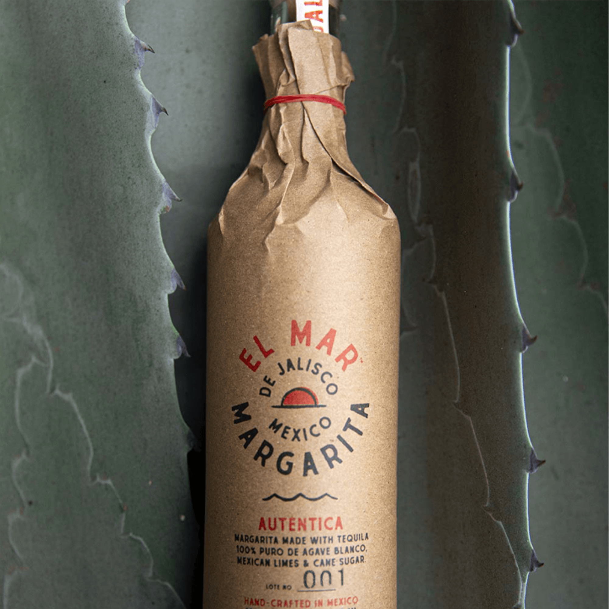 El Mar Margarita bottle wrapped in rustic paper, featuring natural ingredients like 100% agave tequila and Mexican limes.