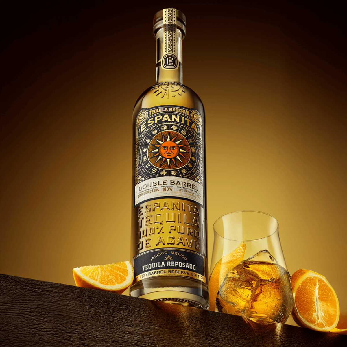 Espanita Double Barrel Reposado Tequila bottle with glass and orange slices, showcasing rich flavors and elegant packaging.