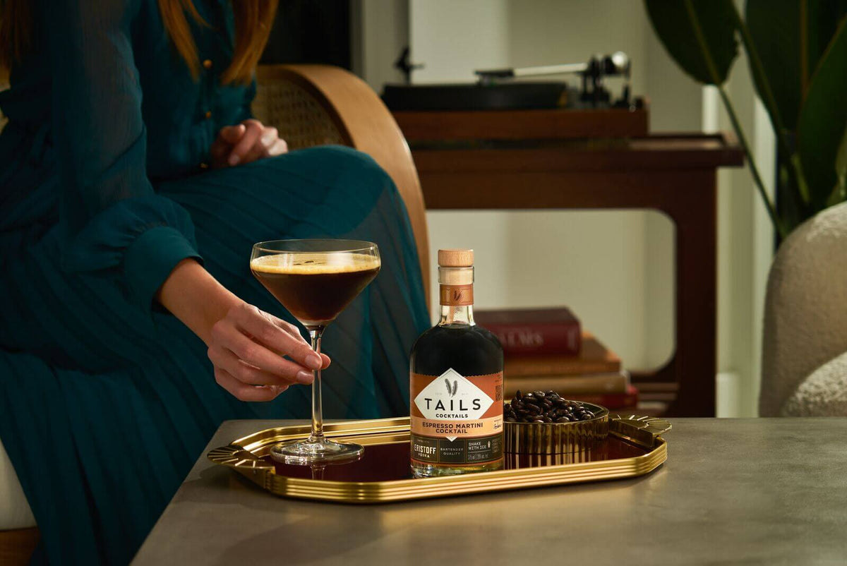 Enjoying a Tails Espresso Martini with rich coffee flavors, garnished with coffee beans for tradition.