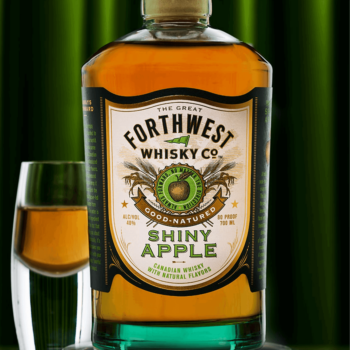 Forthwest Shiny Apple Whisky 700ml bottle with a glass, showcasing its vibrant apple flavor.