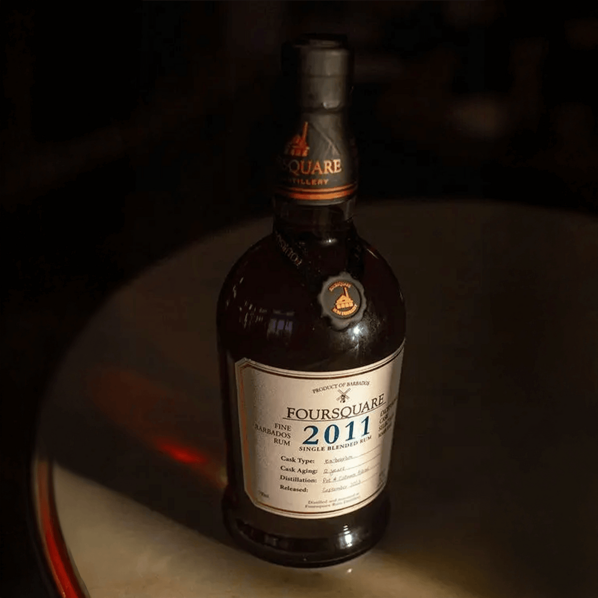 Foursquare Exceptional Cask Selection Mark XXIV 2011 Rum bottle on a table, showcasing its elegant design.