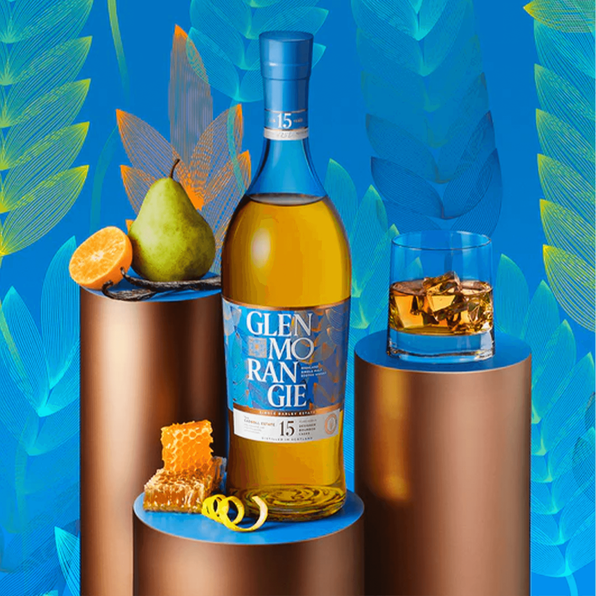 Glenmorangie 15 Year Cadboll Estate Batch 4 whisky with fruits and honeycomb, set against a vibrant blue background.