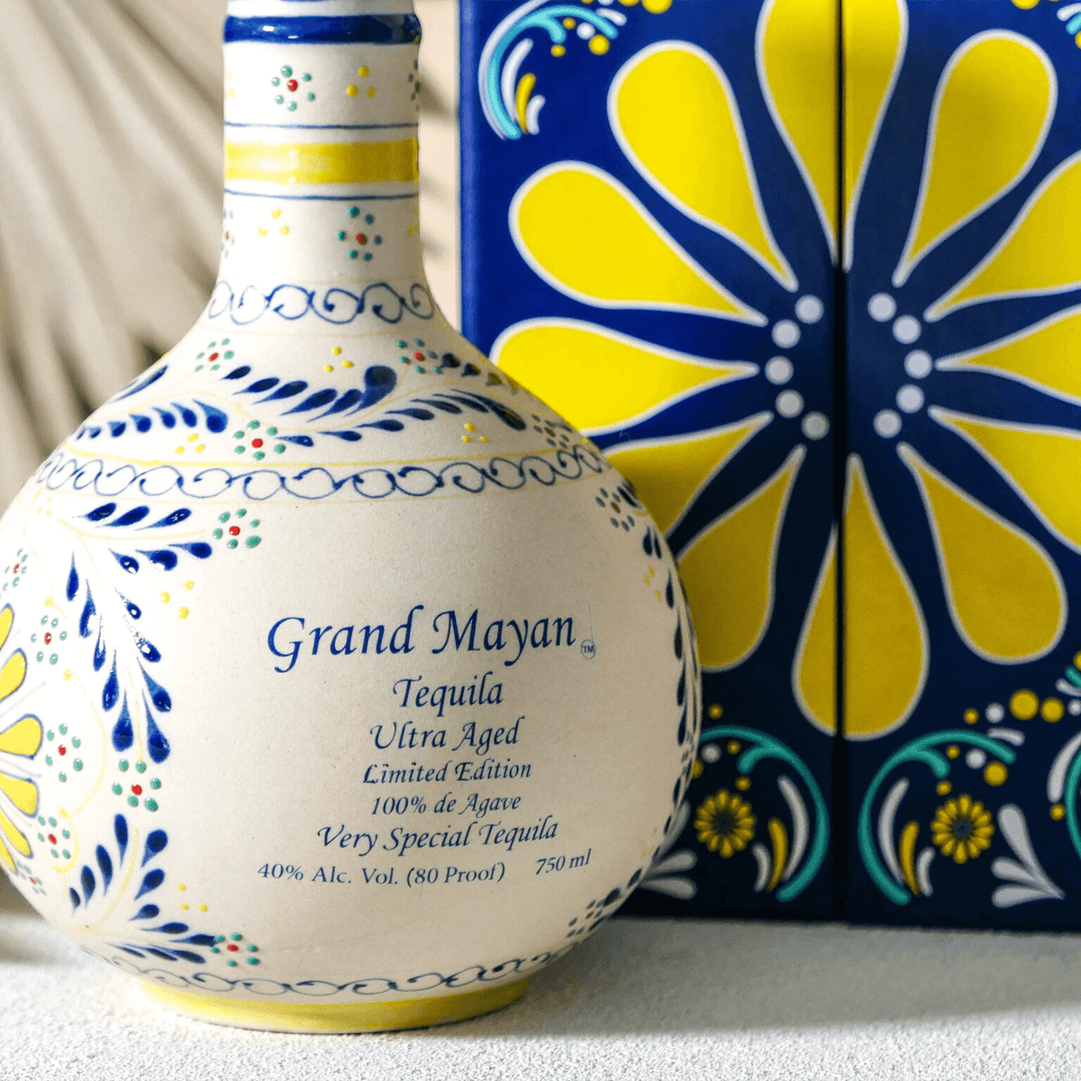 Grand Mayan Ultra Añejo Tequila bottle with colorful design and packaging, showcasing limited edition craftsmanship.