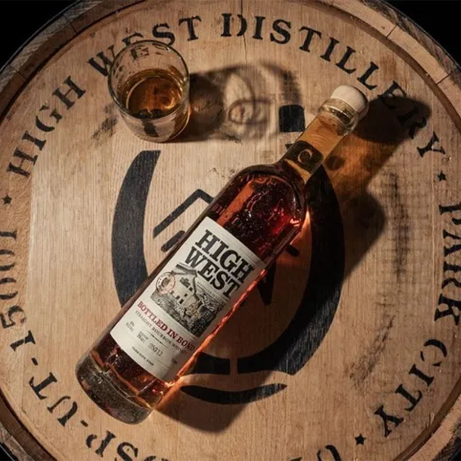 High West Batch No 25G09 Bottled In Bond Bourbon with a glass on a barrel at High West Distillery.