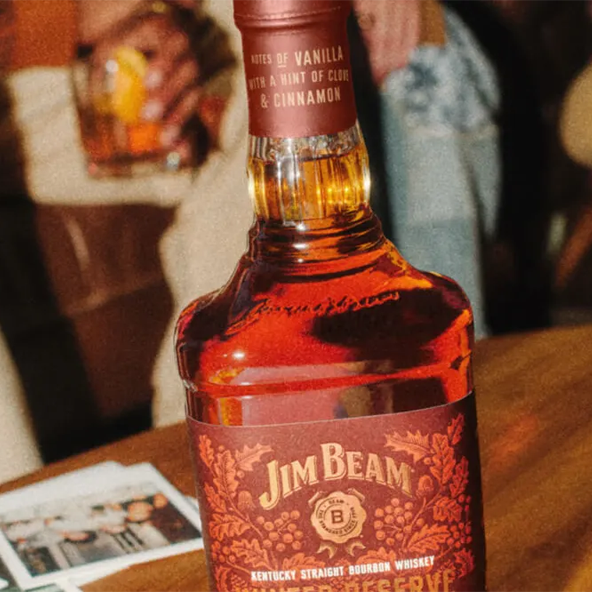Jim Beam Winter Reserve Bourbon bottle featuring notes of vanilla and cinnamon in a cozy setting.