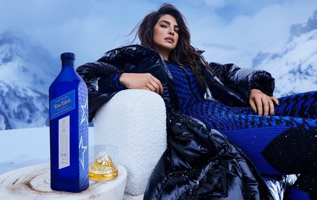 Johnnie Walker Blue Label Ice Chalet Scotch bottle with ice, luxury ski wear, ideal for aprés-ski experiences.