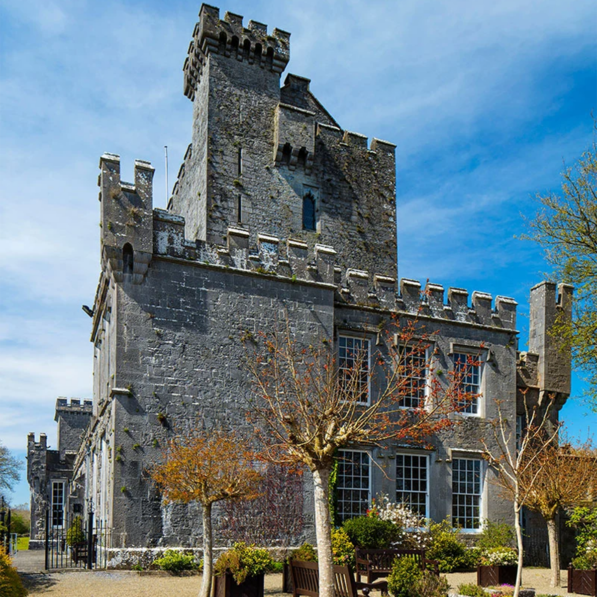 Knappogue Castle exterior view, showcasing its historic architecture and surrounding trees.