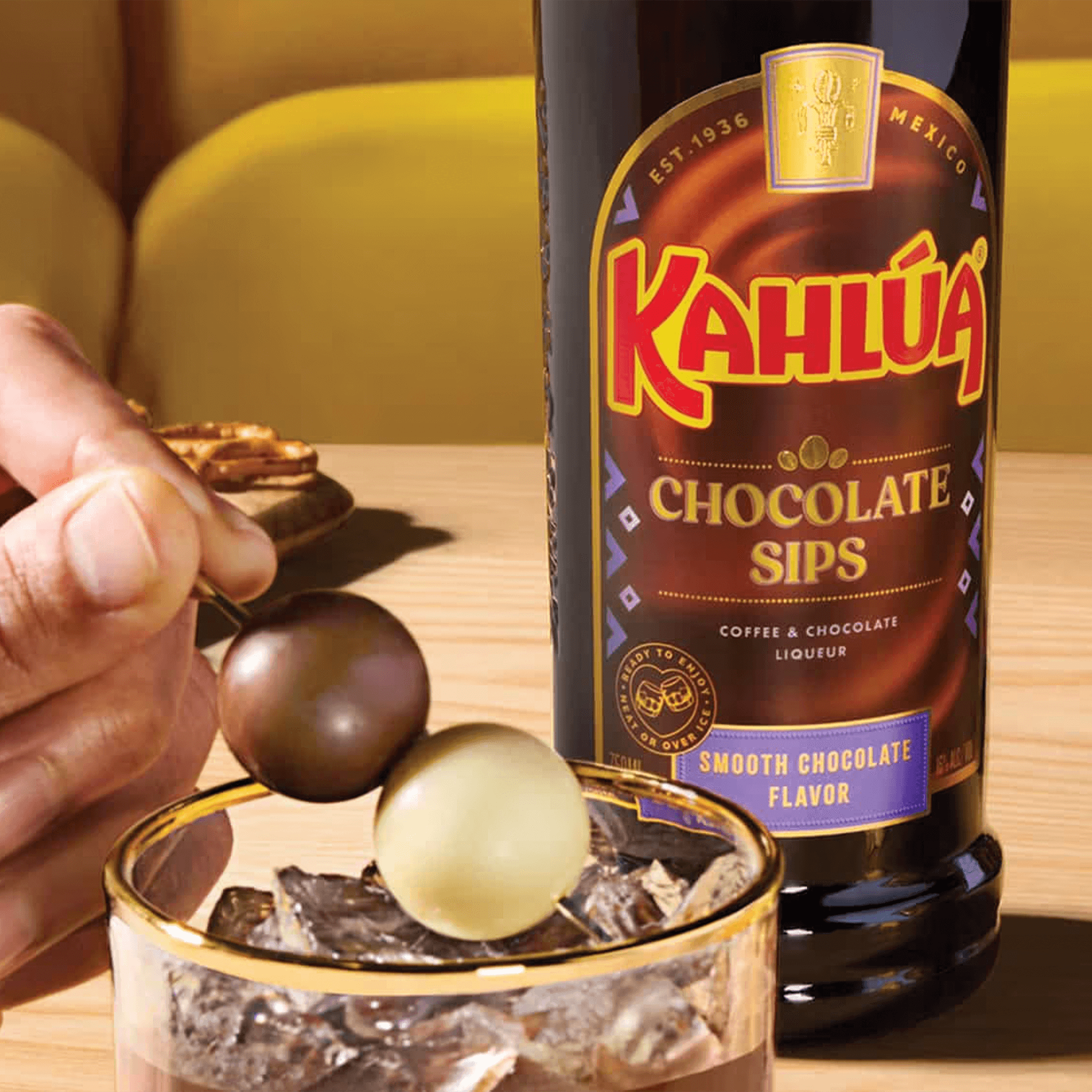 Kahlúa Chocolate Sips liqueur displayed with smooth chocolate truffles, highlighting its rich coffee and cocoa flavor.