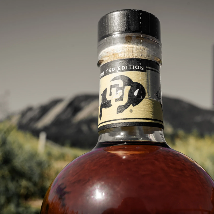 Laws Whiskey House Ralphie's Reserve Bourbon bottle close-up with a mountainous background.
