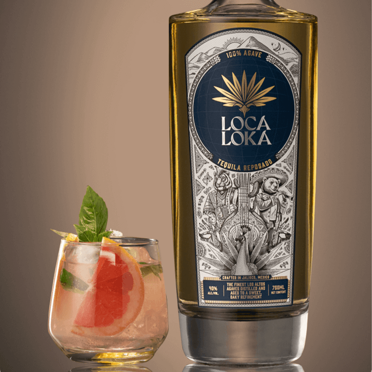 Loca Loka Reposado Tequila bottle with cocktail garnished with mint and grapefruit.