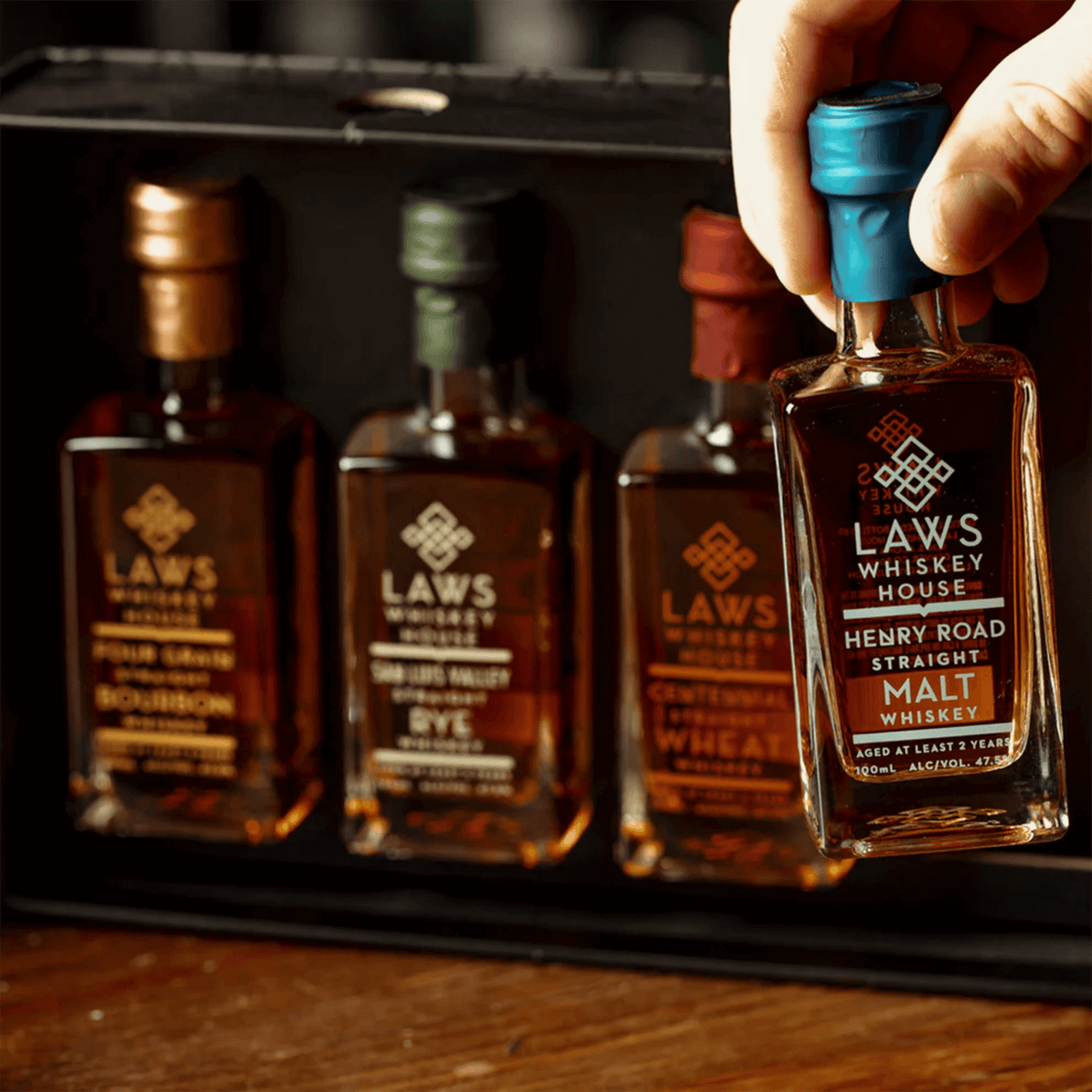Laws Whiskey House Set featuring four 100ml bottles including Bourbon, Rye, and Malt Whiskeys in a gift pack.