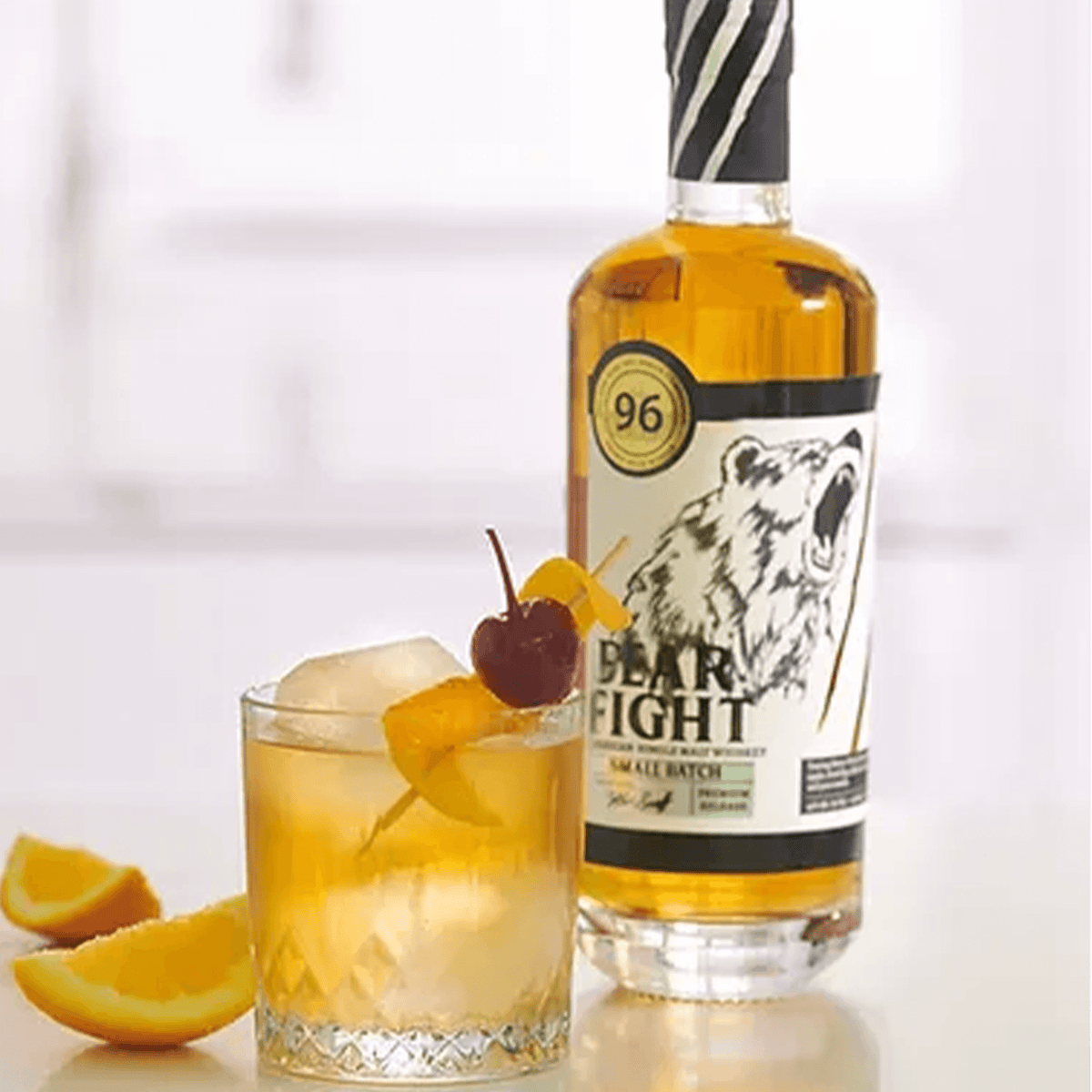 Bear Fight American Single Malt Whiskey in a cocktail glass with garnishes, showcasing the bold flavors and elegance.