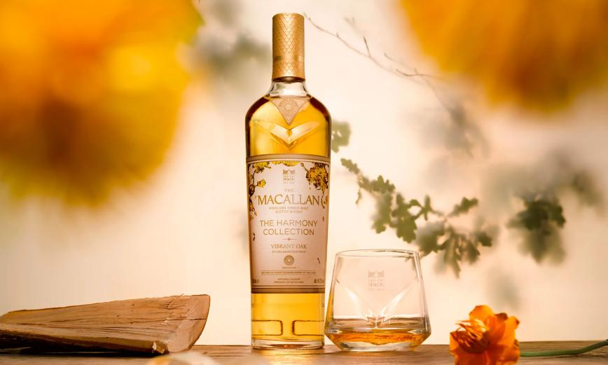 Macallan Harmony Collection Vibrant Oak Single Malt Scotch whiskey bottle and glass with floral background.