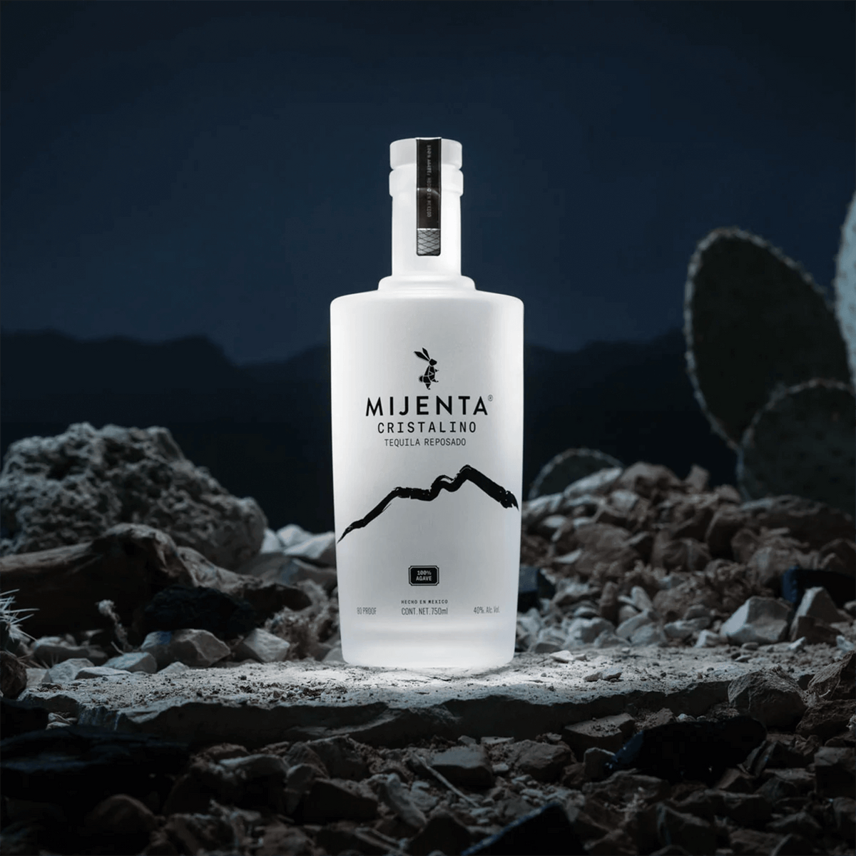 Mijenta Cristalino Tequila bottle with elegant design, set against a rocky landscape, highlighting its premium quality.