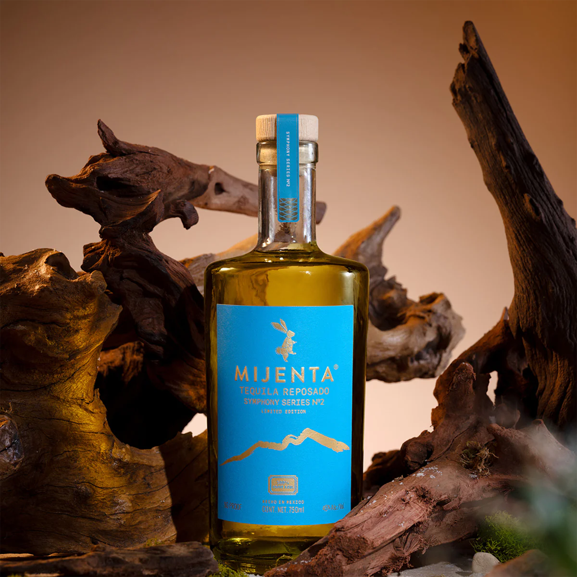 Mijenta Reposado Symphony Series No. 2 Tequila bottle against a rustic wood backdrop.