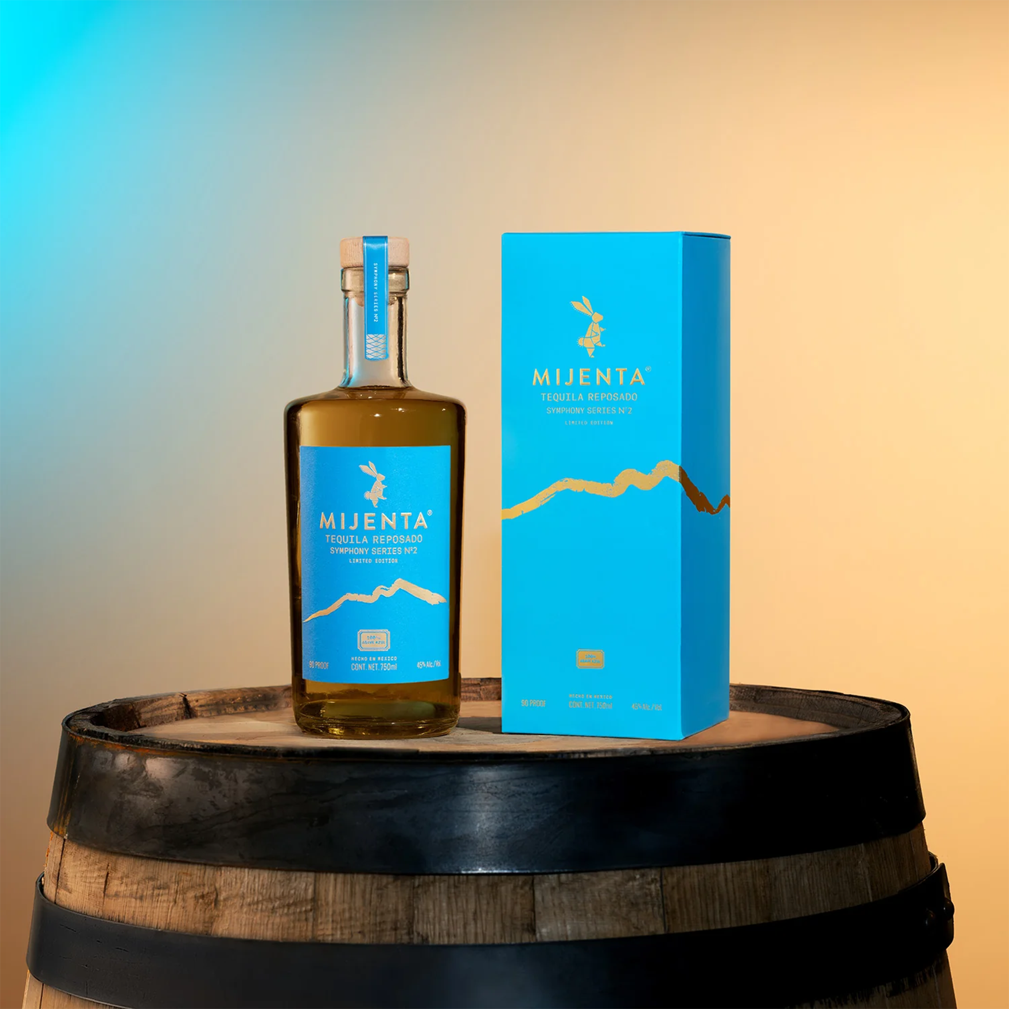 Mijenta Reposado Symphony Series No. 2 Tequila bottle and box on a wooden barrel.