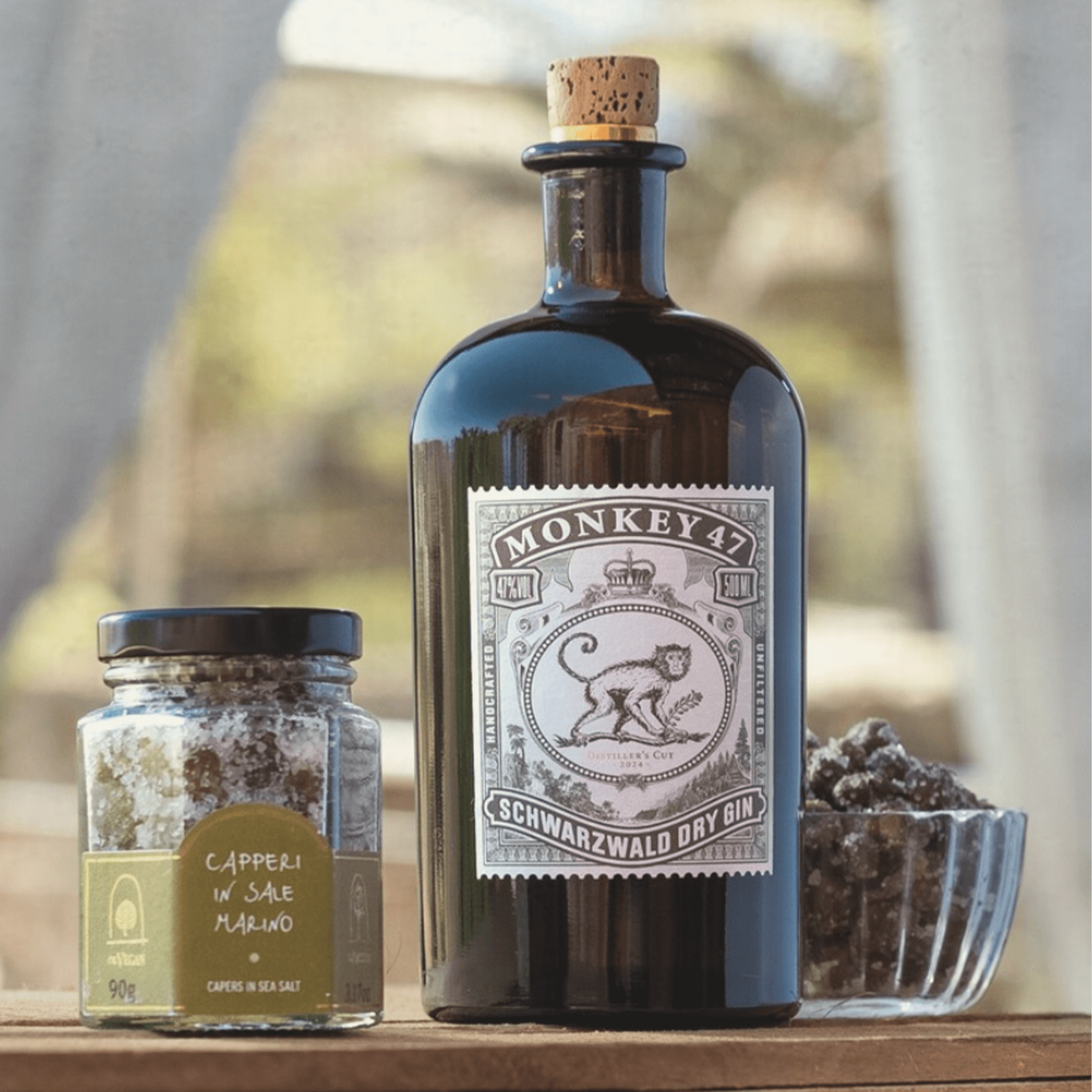Monkey 47 Distillers Cut 2023 gin bottle with capers in sea salt, showcasing elegant design and exceptional quality.