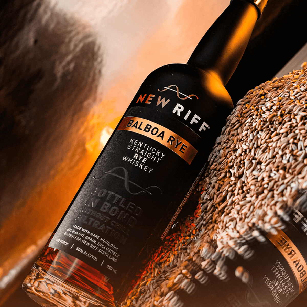 New Riff Balboa Rye Whiskey bottle surrounded by grains, showcasing heirloom rye whiskey craftsmanship.